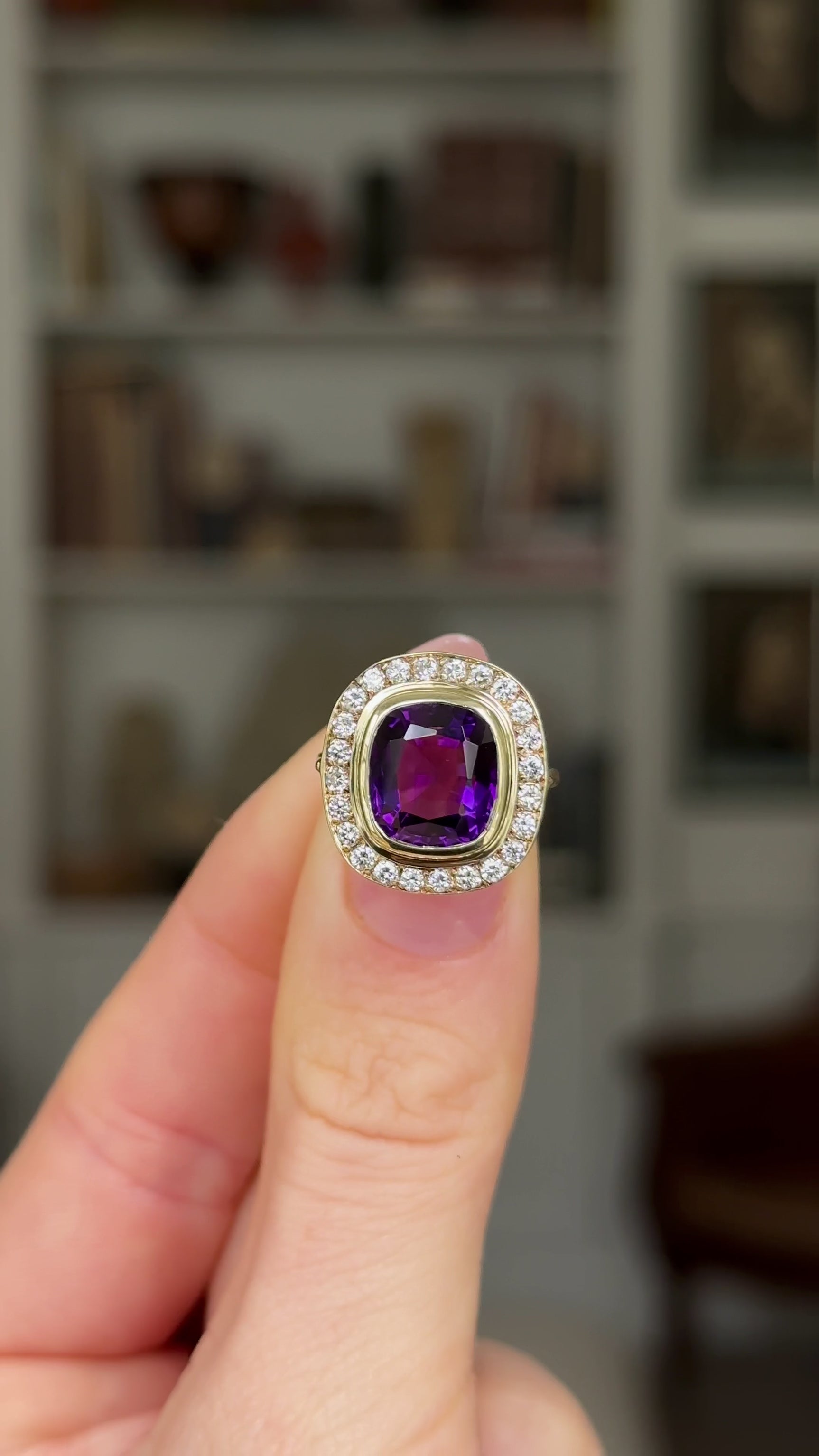 Vintage, 1970s Amethyst and Diamond Cluster Ring, 18ct Yellow Gold held in fingers and rotated to give perspective.