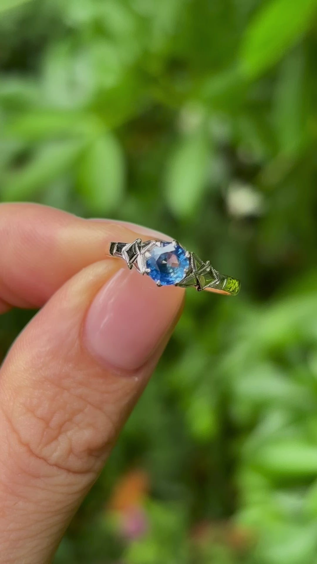 Vintage, 1960s single-stone sapphire ring held in fingers.