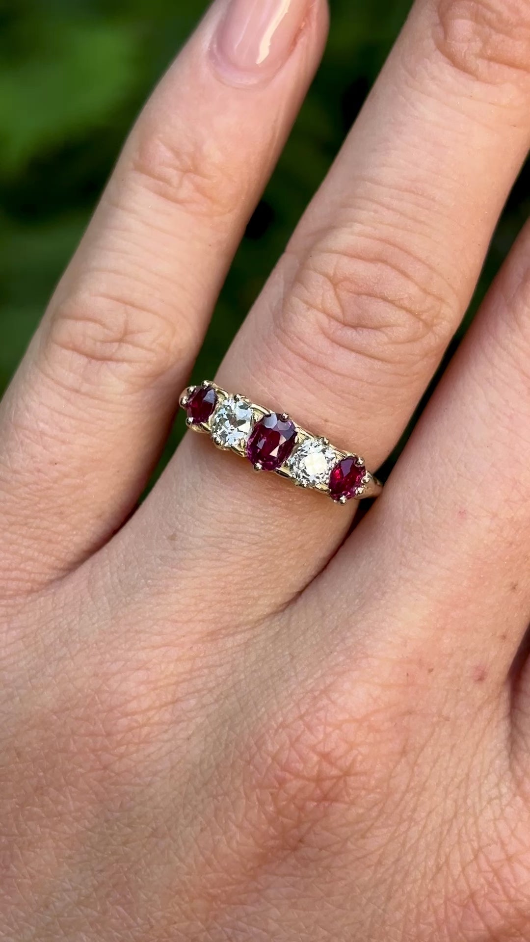 Antique, Victorian ruby & diamond five-stone ring worn on hand.