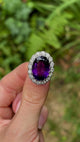 Antique, vintage amethyst & diamond cluster ring in fingers.