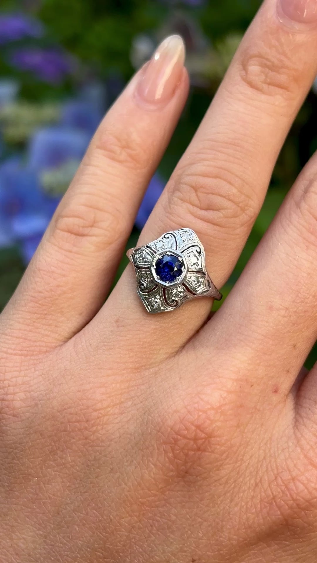 Vintage, 1930s sapphire and diamond ring worn on hand.