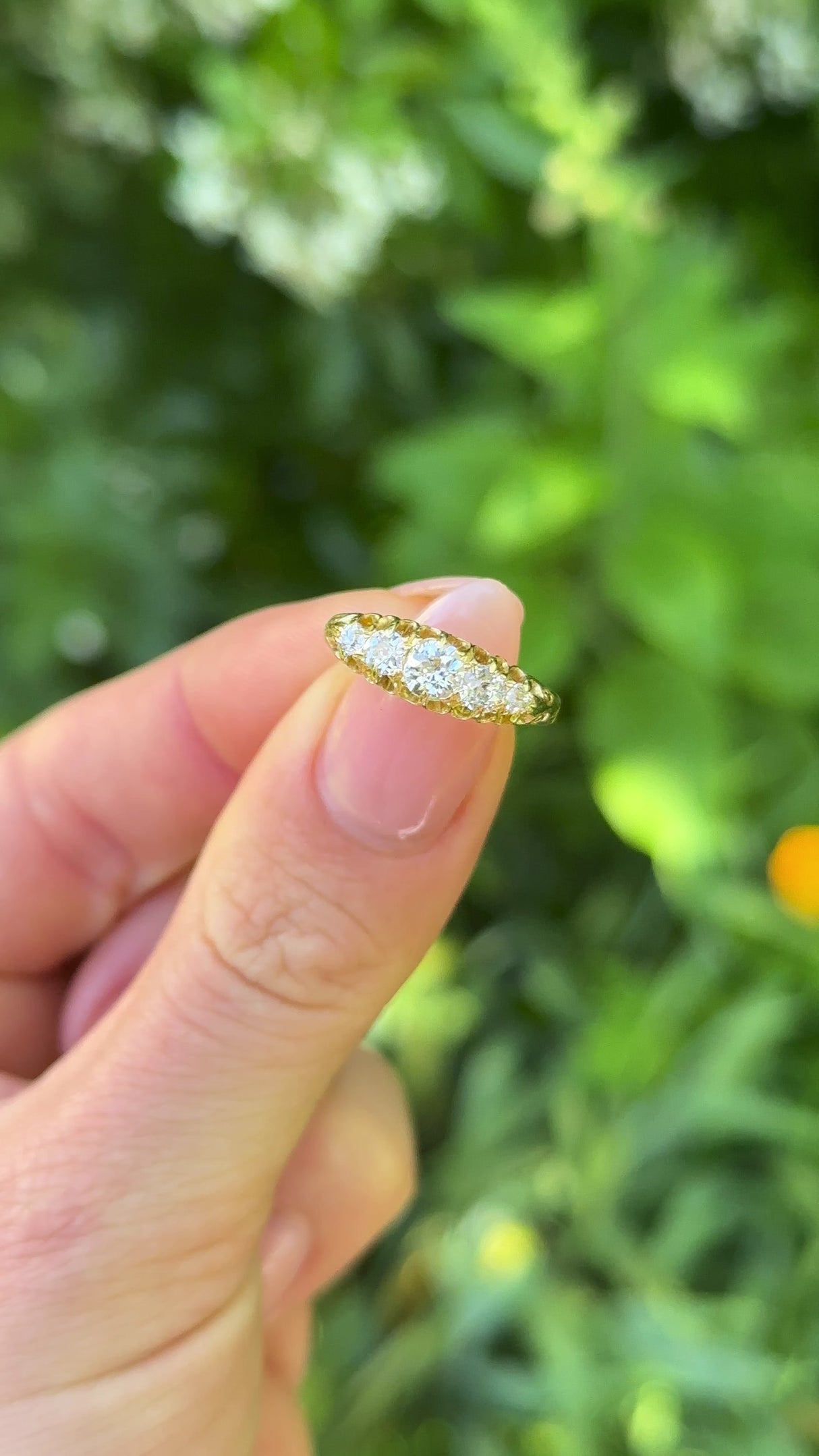 Antique, Edwardian Five-Stone Diamond Ring, 18ct Yellow Gold held in fingers.