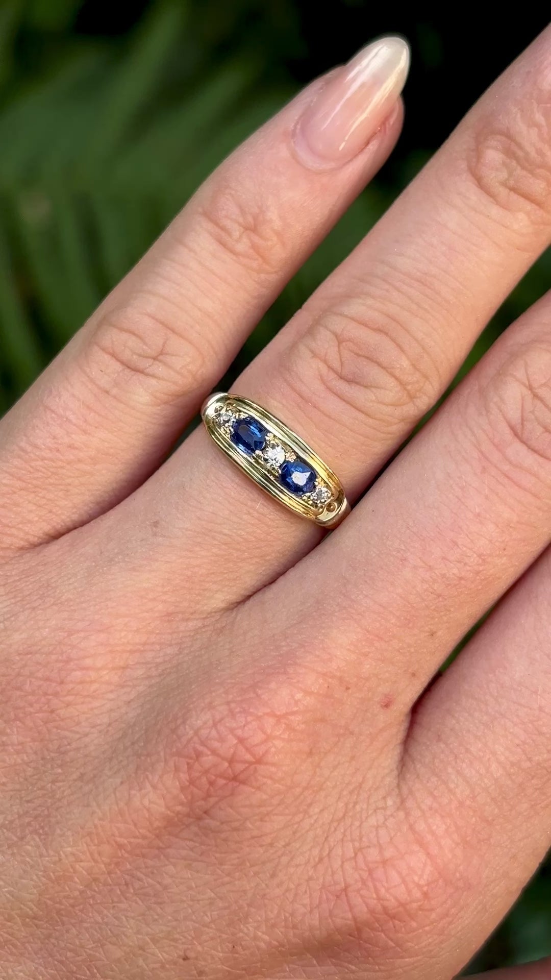 Vintage, Art Deco sapphire & diamond five-stone ring worn on hand.