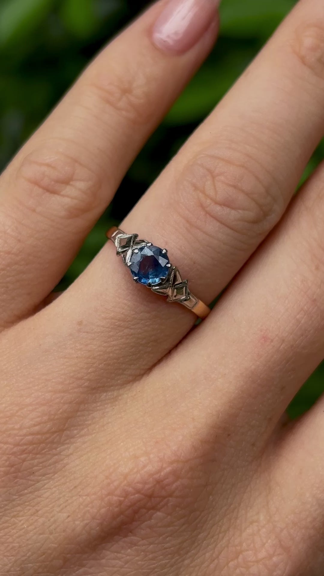 Vintage, 1960s single-stone sapphire ring worn on hand.