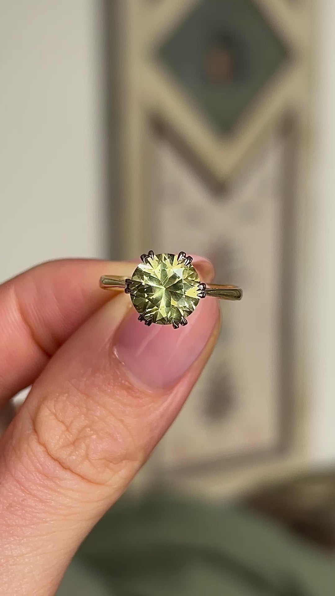 Vintage, 1980s single-stone chrysoberyl ring held in fingers. 