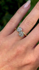 Antique, Edwardian diamond cluster ring worn on hand.