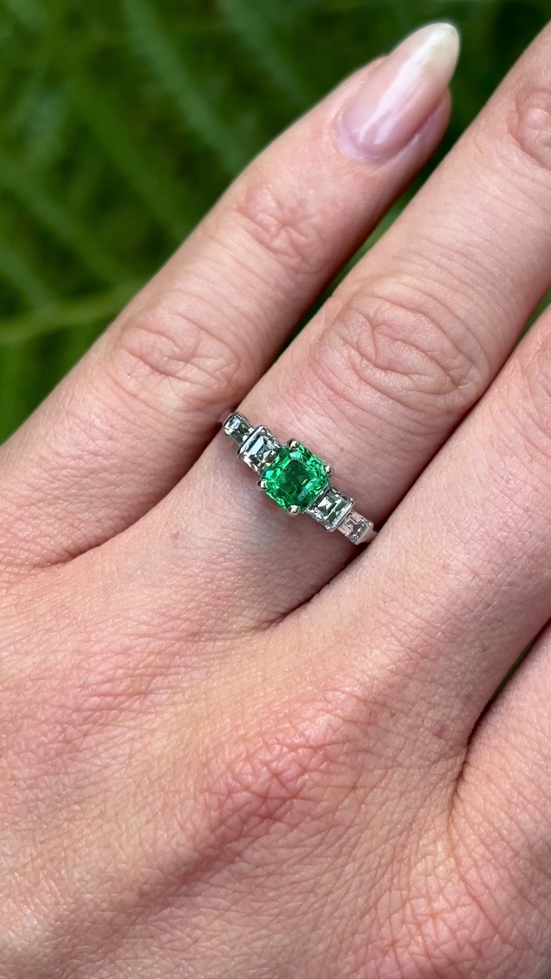 Vintage, Art Deco emerald & diamond five-stone ring worn on hand.