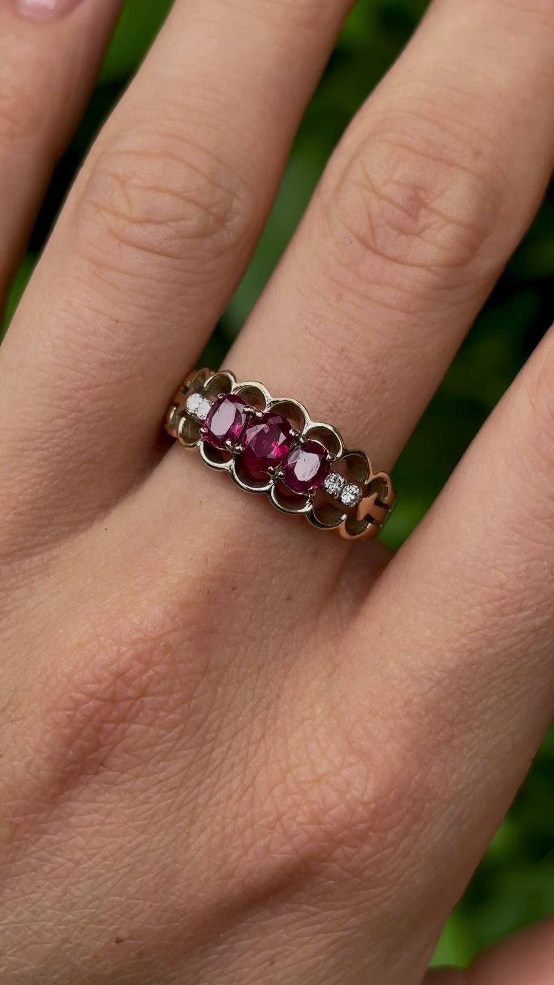 Vintage, 1980s ruby and diamond three-stone ring worn on hand.