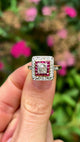 Vintage, diamond and ruby cluster ring, 18ct yellow gold and platinum held in fingers and rotated.