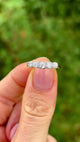 Antique, Edwardian half-hoop diamond ring, 18ct yellow gold and platinum held in fingers