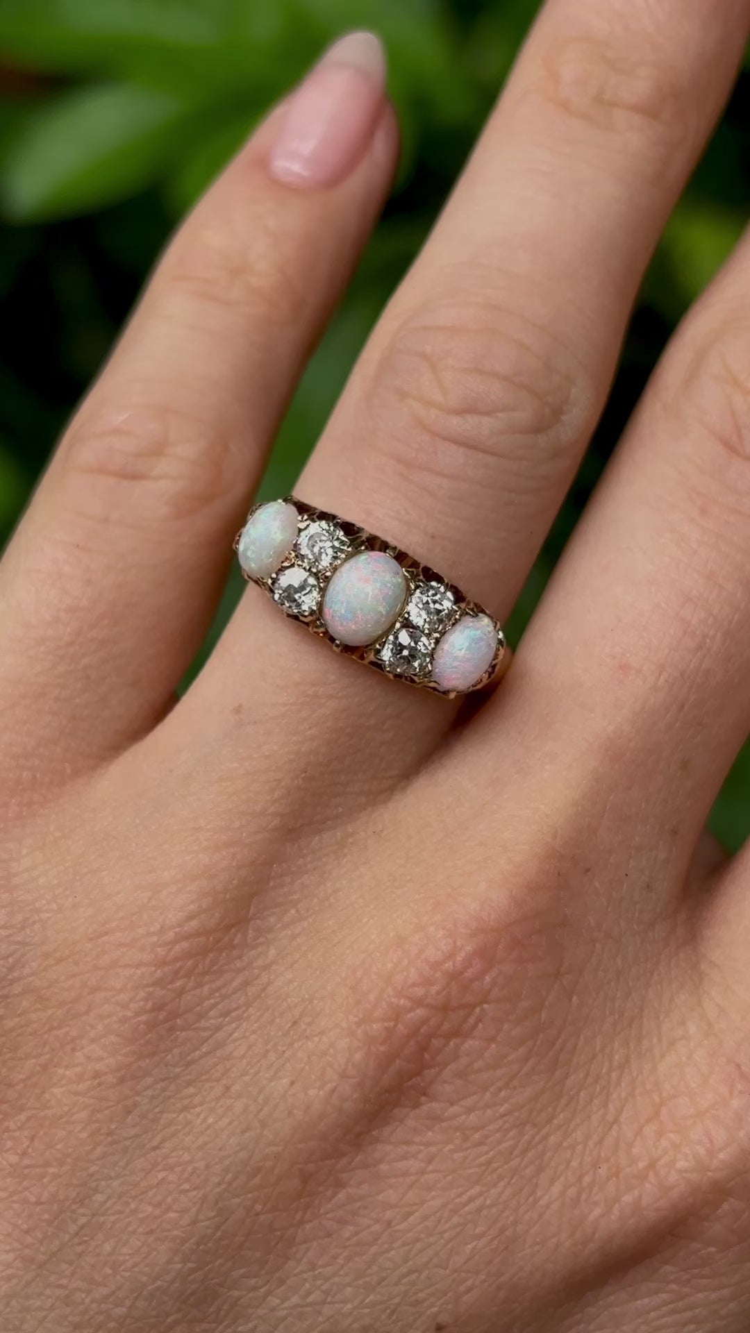 Victorian, opal & diamond three-stone ring worn on hand.