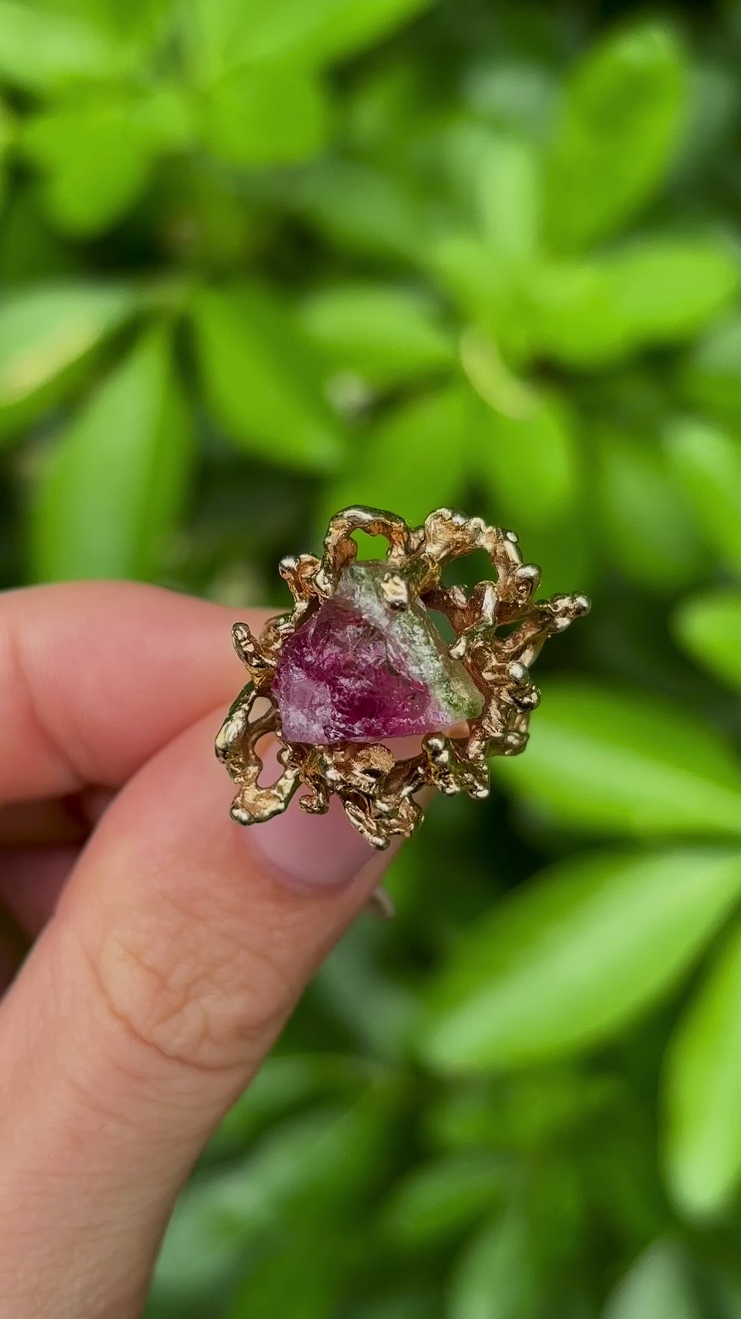 Vintage, 1970s watermelon tourmaline cocktail ring held in fingers.