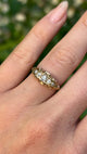 Antique, Edwardian five-stone diamond ring worn on hand and moved around