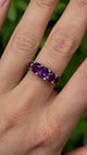 Antique, Victorian five-stone amethyst ring worn on hand.