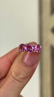 2077-Vintage, 1930s pink sapphire three-stone ring  held in fingers