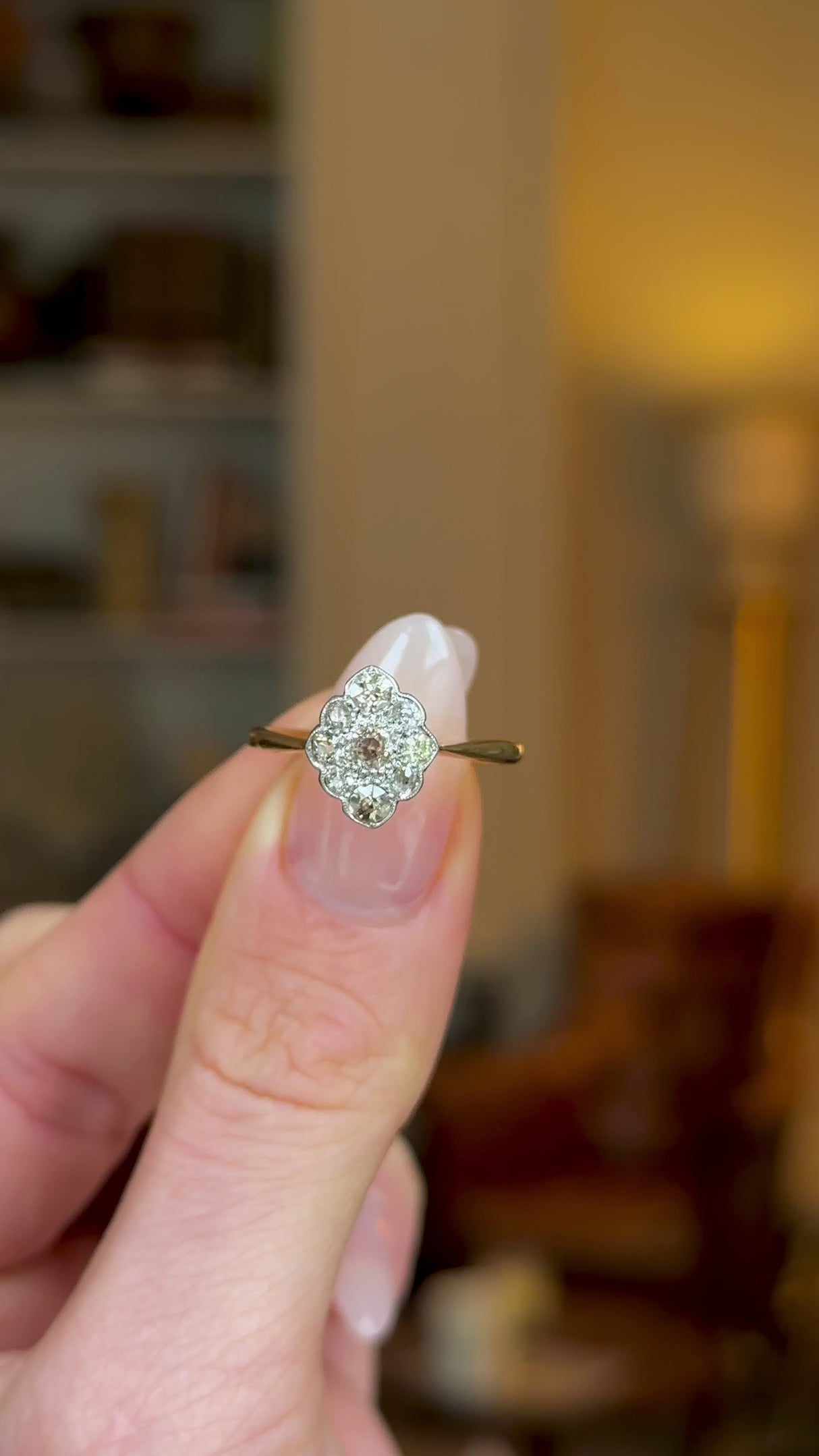 Antique, Edwardian Kite-Shaped Diamond Engagement Ring, 18ct Yellow Gold and Platinum held in fingers and rotated to give perspective.