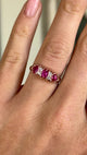 Antique, Victorian pinky-red ruby & diamond half-hoop ring worn on hand.