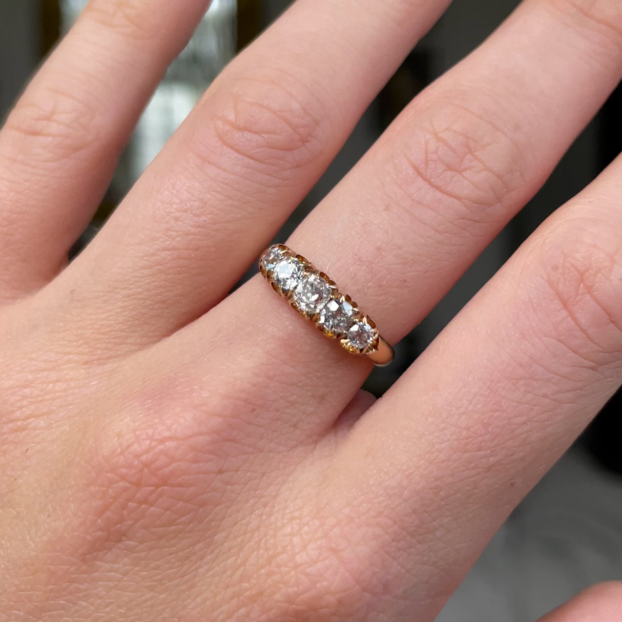 Victorian five stone diamond engagement ring, worn on hand and moved around to give perspective.