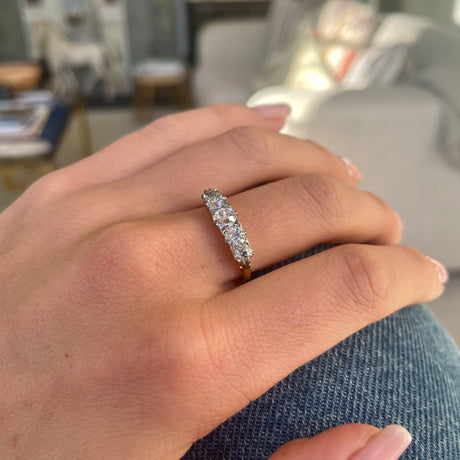 Victorian five-stone diamond engagement ring, worn on hand.