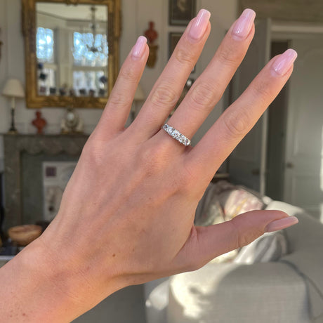 Victorian five-stone diamond engagement ring, worn on hand.