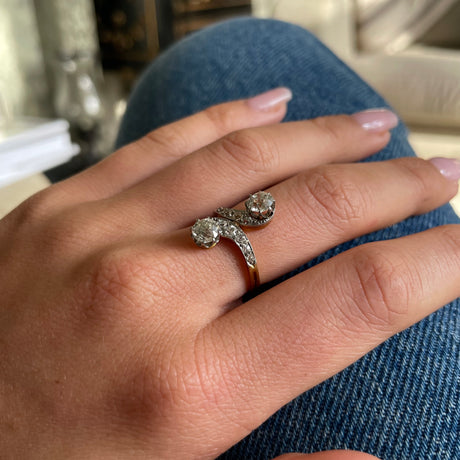 vintage toi et moi diamond ring, worn on hand placed on denim jeans.