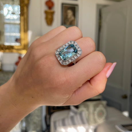 Art Deco aquamarine and diamond cluster ring, worn on hand.