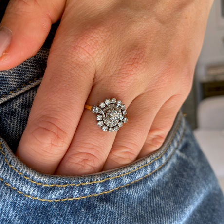 Antique French diamond cluster engagement ring, worn on hand.