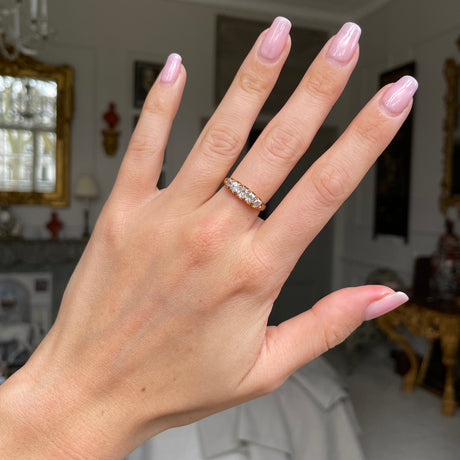 Victorian five stone diamond engagement ring, worn on hand.