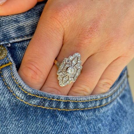 Art Deco diamond navette engagement ring, worn on hand.