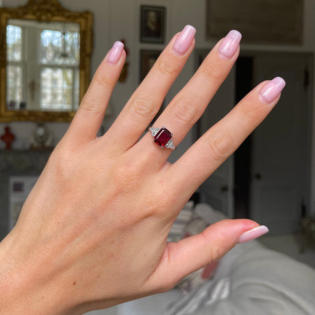 Art Deco garnet and diamond engagement ring, worn on hand.