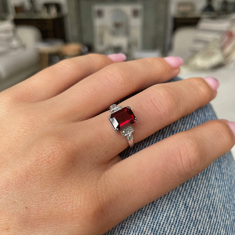 Art Deco garnet and diamond engagement ring, worn on hand.