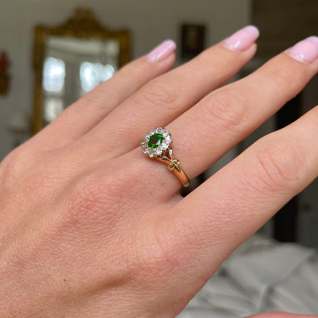 Edwardian, demantoid garnet and diamond cluster ring, worn on hand.