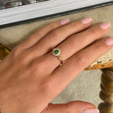Edwardian, demantoid garnet and diamond cluster ring, worn on hand.