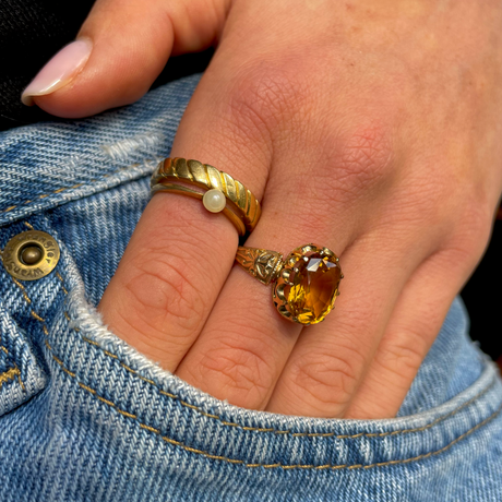 Imperial topaz single stone ring, worn on hand placed in pocket of jeans.