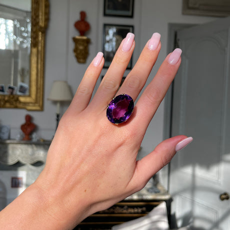 Victorian amethyst cocktail ring, worn on hand.