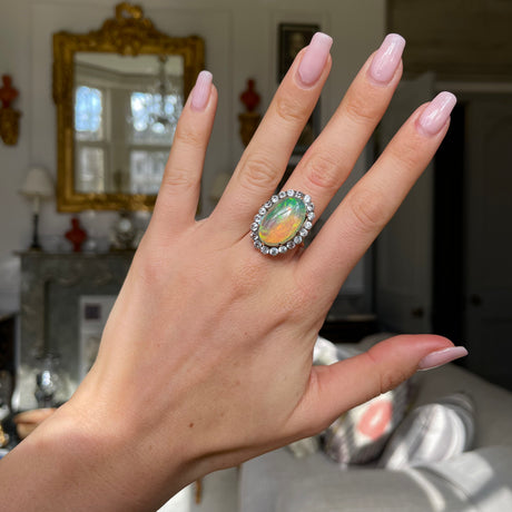 Antique opal and paste cluster ring, worn on hand.