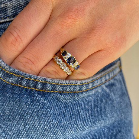 sapphire and diamond engagement ring, worn on hand.