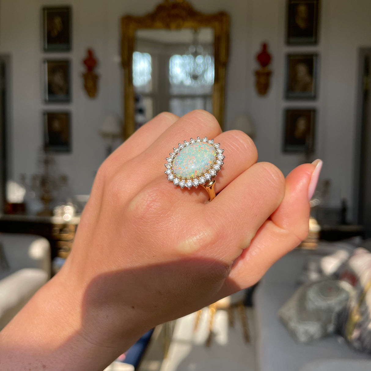 Vintage white Australian opal and diamond ring, worn on hand. 