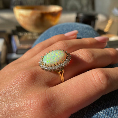 Vintage white Australian opal and diamond ring, worn on hand. 