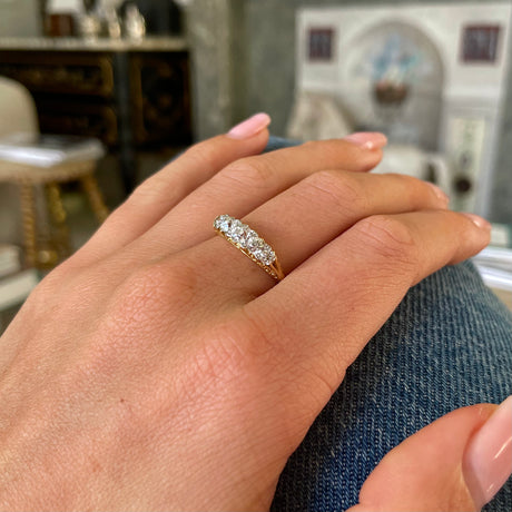 Victorian five stone diamond engagement ring, worn on hand.