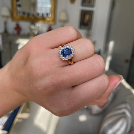 Victorian, sapphire and diamond cluster engagement ring, worn on hand.