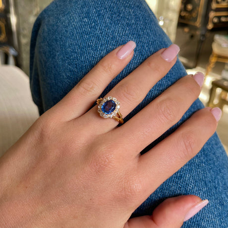 Victorian, sapphire and diamond cluster engagement ring, worn on hand.