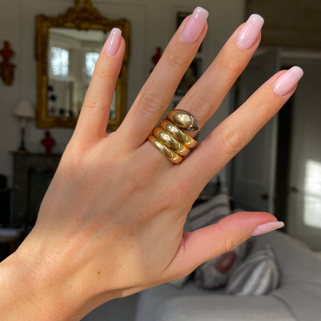 Victorian yellow gold snake ring, worn on hand.