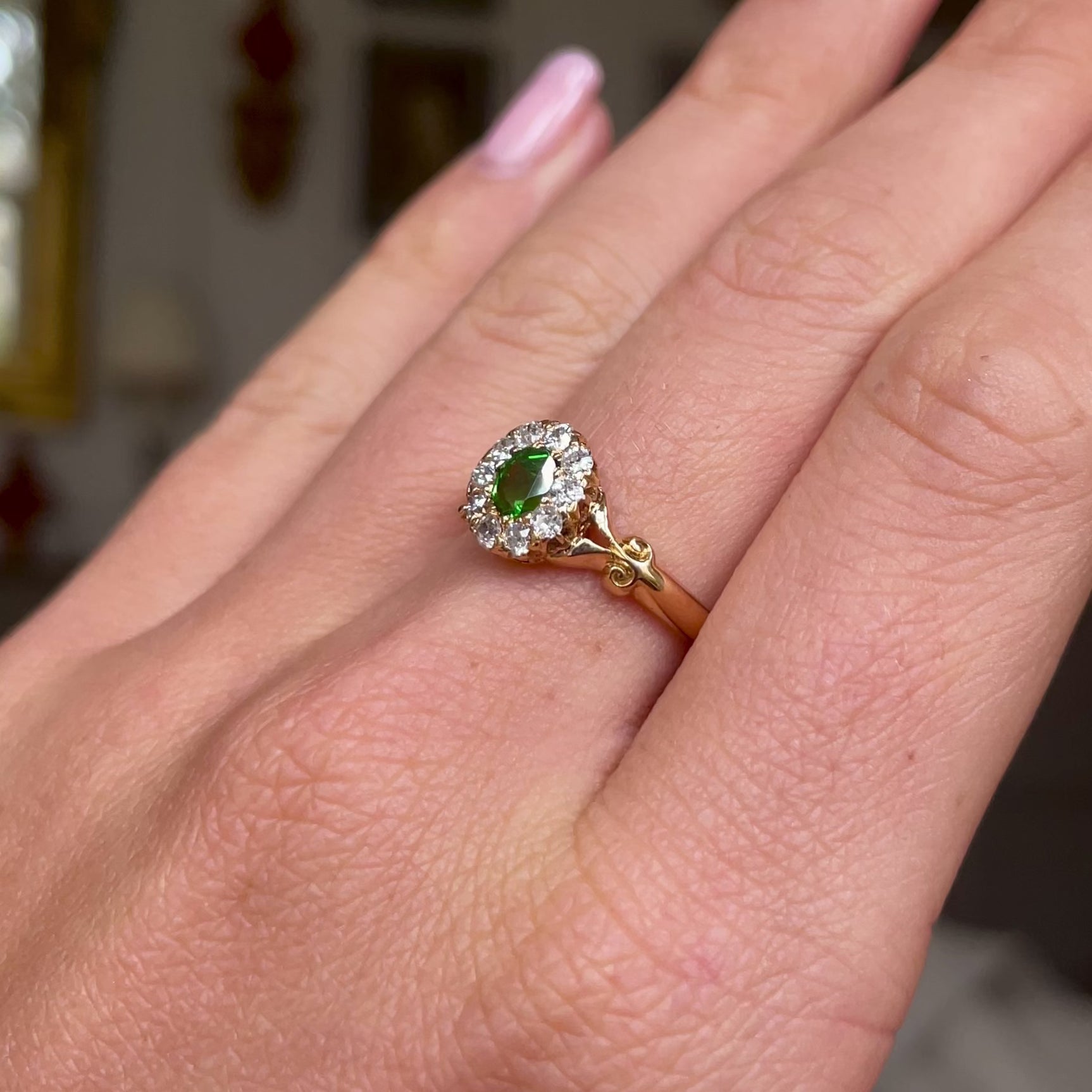 Edwardian, demantoid garnet and diamond cluster ring, worn on hand and rotated to give perspective.