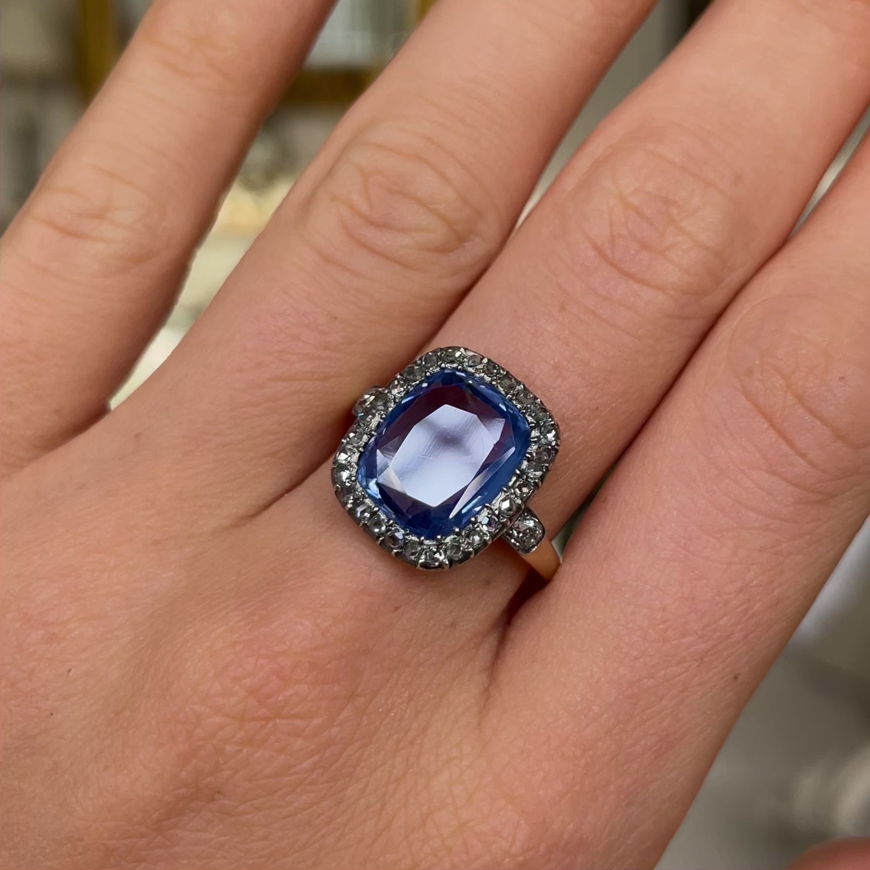 Early Victorian sapphire and diamond engagement ring, worn on hand and rotated to give perspective.